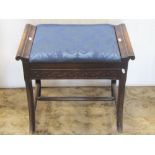 An Edwardian piano stool, the shallow upholstered box seat, with scrolled ends over a blind fret