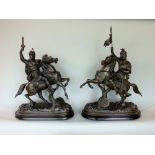 Pair of French cast spelter character groups of knights on rampant horses upon ebonised wooden