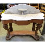 A Victorian walnut tilt top breakfast or loo table of oval form with inlaid detail, raised on turned