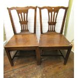 A pair of early Georgian country made dining chairs in mixed woods including ash and elm with