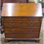 Georgian oak bureau of four long graduated drawers crossbanded in walnut, the fall flap enclosing