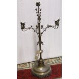 A Gothic revival brass four branch candelabra, the knop stem with foliate detail raised on a domed