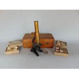 Early 20th century cased brass and ebonised students microscope, together with two boxes of Flatters