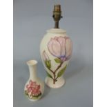 A cream ground Moorcroft table lamp base with magnolia decoration and impressed marks to base,