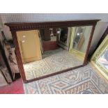An Edwardian overmantel mirror of rectangular form with bevelled edge plate within a moulded
