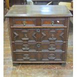 A small 18th century oak chest of four long drawers with applied geometric mouldings, additional