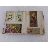 A small late 19th century scrap album containing an interesting collection of cut out images,