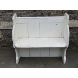A small pine pew with planked seat, chamfered ends and later painted finish, 3ft long