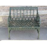 A small reproduction green painted cast aluminium two seat garden bench in the Regency Gothic