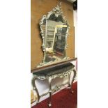 A reproduction console table and matching mirror, with shaped outline, scrolling acanthus detail and