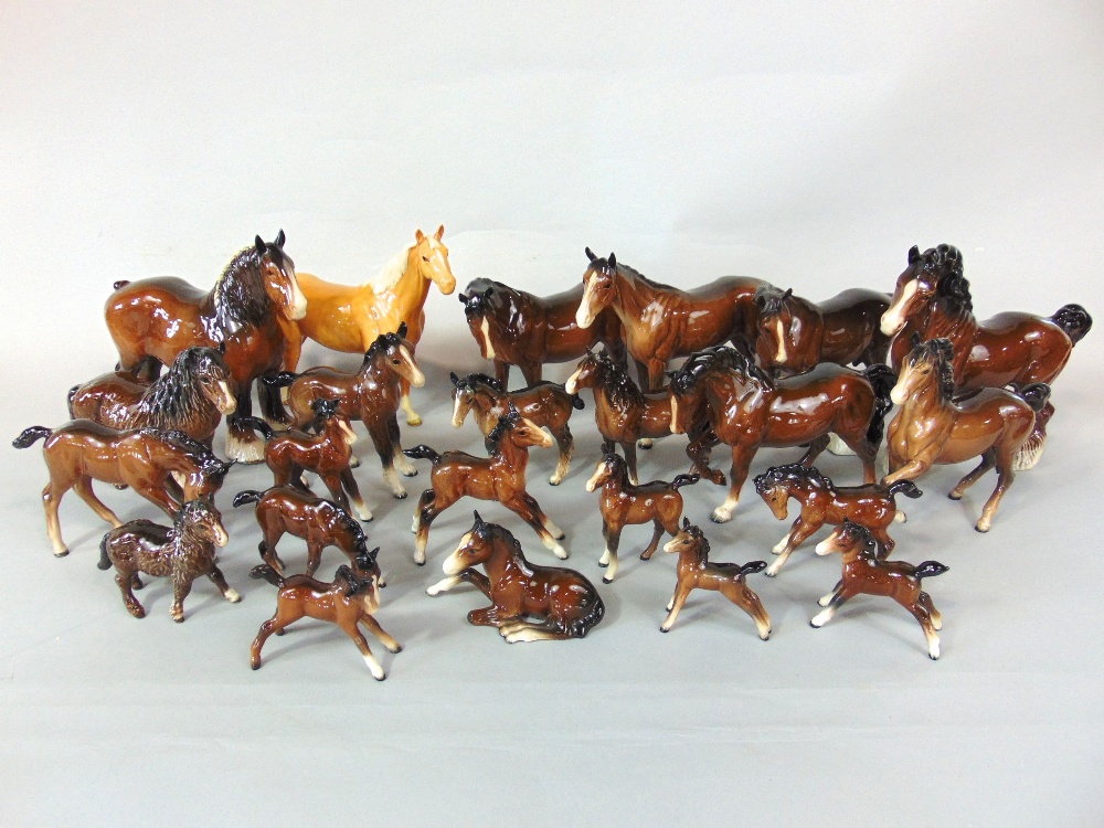 A collection of mainly Beswick model horses and foals including a palomino horse, shire horses,