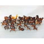 A collection of mainly Beswick model horses and foals including a palomino horse, shire horses,