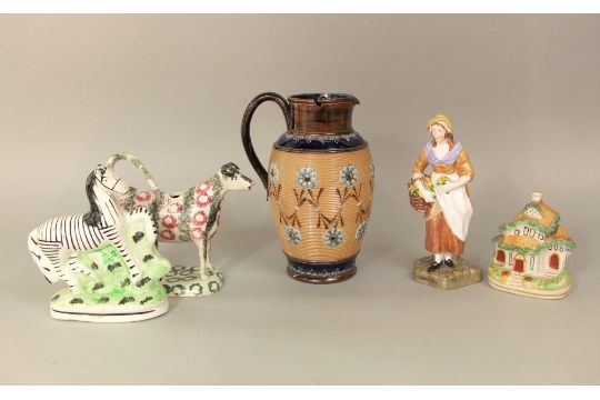 A 19th century cow creamer in the form of a standing cow and milkmaid, decorated with sponged type - Image 1 of 2