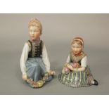 A pair of Royal Copenhagen Amager figures of children in Danish national costume the boy holding a