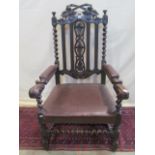 A Victorian carved oak elbow chair to a Carolean design with acanthus, vine leaf and grape detail