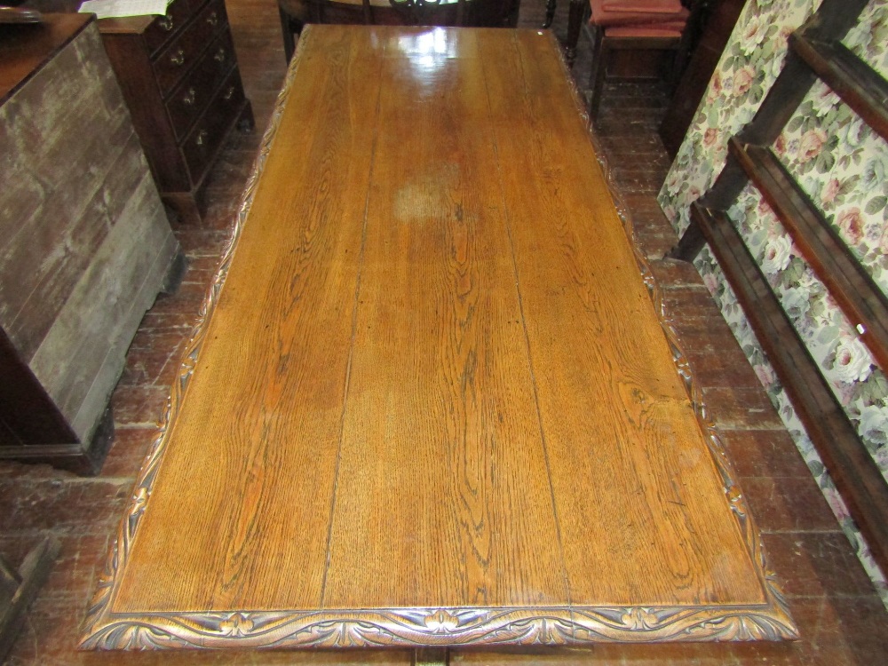 A 19th century oak refectory table, the plank top with carved borders, raised on a pair of - Image 2 of 3