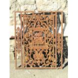 A small 19th century cast iron ecclesiastical door, the rectangular frame enclosing a decorative