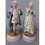 A pair of continental bisque figures of a lady and gentleman in 18th century style costume holding