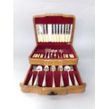 Elm veneered two tier canteen of silver plated cutlery