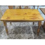 A late Victorian stained pine kitchen table of rectangular form, the frieze incorporating an end