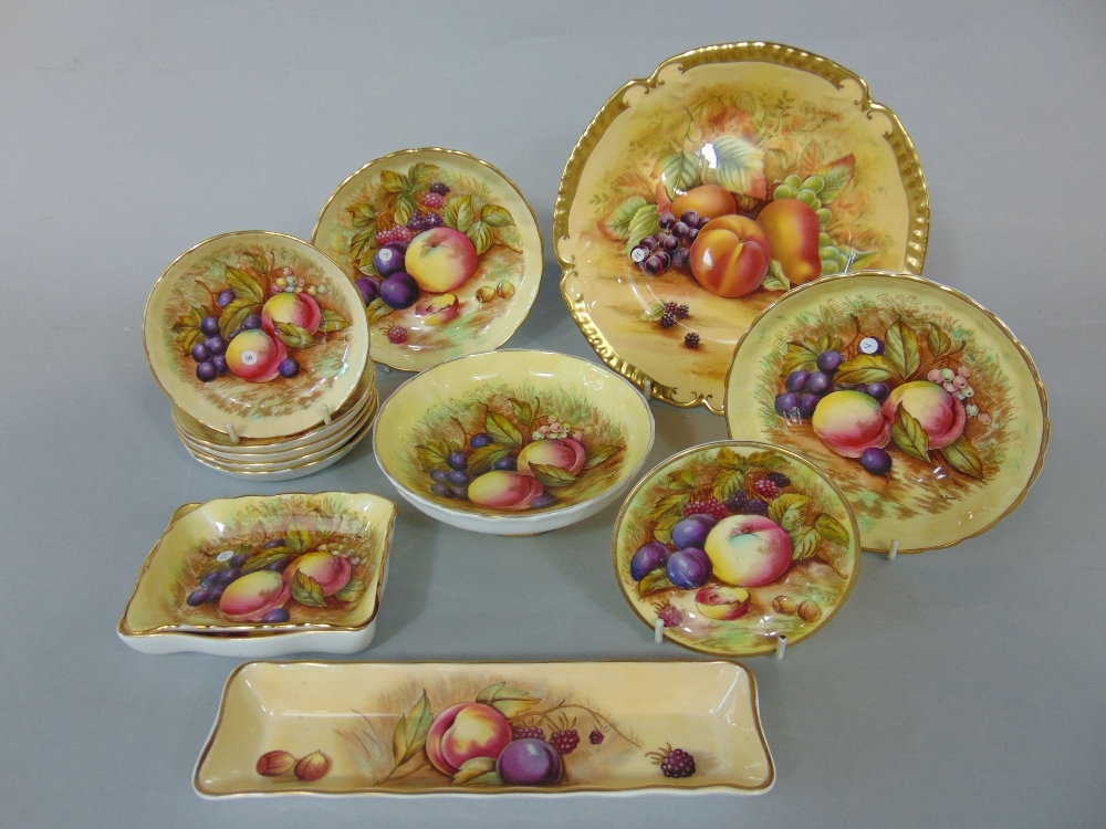 A collection of Aynsley Orchard Gold pattern bowls and dishes of various size including circular