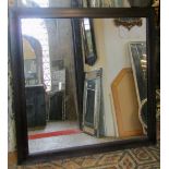 A large cushion moulded mirror with dark stained finish and simple mirror plate, 130cm square