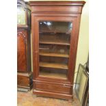 A substantial mahogany bookcase or display cabinet enclosed by a single glazed panelled door over