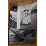A box containing an extensive quantity of black and white photographs dating from the 1950s and