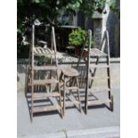 Two vintage pine folding step ladders together with a further folding work stool with elm seat (to