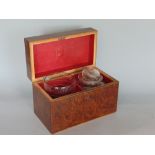 19th century burr or yew wood tea caddy, the hinged lid enclosing an interior fitted with a decanter