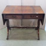 A reproduction Regency style sofa table, fitted with two real and two dummy drawers to reverse,