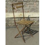 A set of six vintage steel framed folding chairs with wooden strap work seats and backs, each