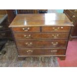 A small Georgian oak country made chest of three long and two short graduated drawers with brass