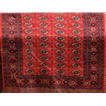 Bokhara carpet with typical geometric decoration of medallions upon a red ground, 250 x 160cm