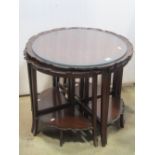 An Edwardian mahogany occasional table of circular form with pie crust border, housing four