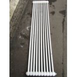 A white painted cast metal radiator with tubular bars, 2m long x 50cm high