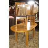 A pale oak extending dining table with single additional leaf, the D end table together with four