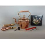 A 19th century copper kettle, together with two further copper gun powder flasks to include one with