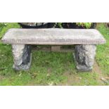A contemporary weathered cast composition stone three sectional garden bench, the rectangular slab