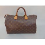 Louis Vuitton Speedy bag in brown monogrammed canvas with vachetta handles, golden brass stamped