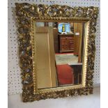 A 19th century Florentine wall mirror, the rectangular gilt frame with pierced scrolling acanthus
