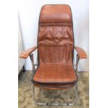 A 1970s Italian Maule Margo folding lounger with tubular frame and tan leather padded seat, back and
