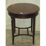 An Edwardian mahogany occasional table of circular form with moulded outline, raised on four