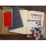Two stamp albums containing a mixture of British and worldwide stamps, a small stock book containing