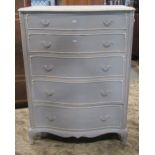 A cream and blue painted bedroom chest, the serpentine front fitted with five long graduated drawers