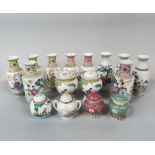 A collection of modern oriental vases with various character and landscape decoration on a white