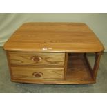 An Ercol Pandora's Box coffee or occasional table, with moulded outline over two drawers and open