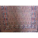 Antique Persian rug with geometric floral decoration upon a burnt orange ground, 160 x 130cm