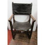 An 18th century continental walnut elbow chair of simple construction with leatherwork seat and