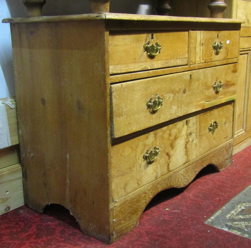 A low late Victorian/Edwardian stripped pine bedroom chest of two short over two long graduated